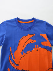 Blue cotton t-shirt with a playful orange crab graphic and orange trim neckline.