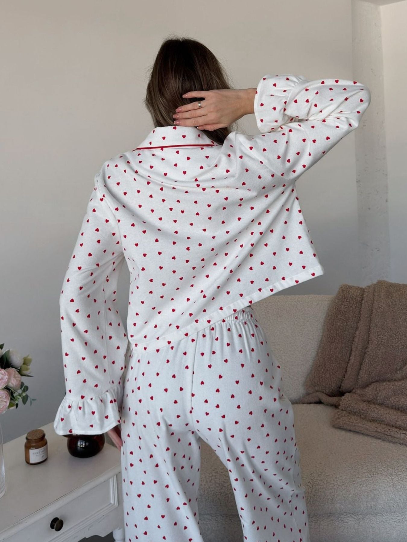 White cotton pajama set with red hearts pattern, ruffled cuffs, and contrast piping.