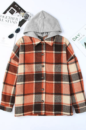Plaid hooded shacket in orange, tan, and brown. Relaxed fit, button front, and cozy hood.