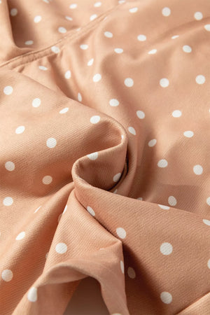 Polka dot wide-leg maternity pants in tan with white dots and drawstring detail.