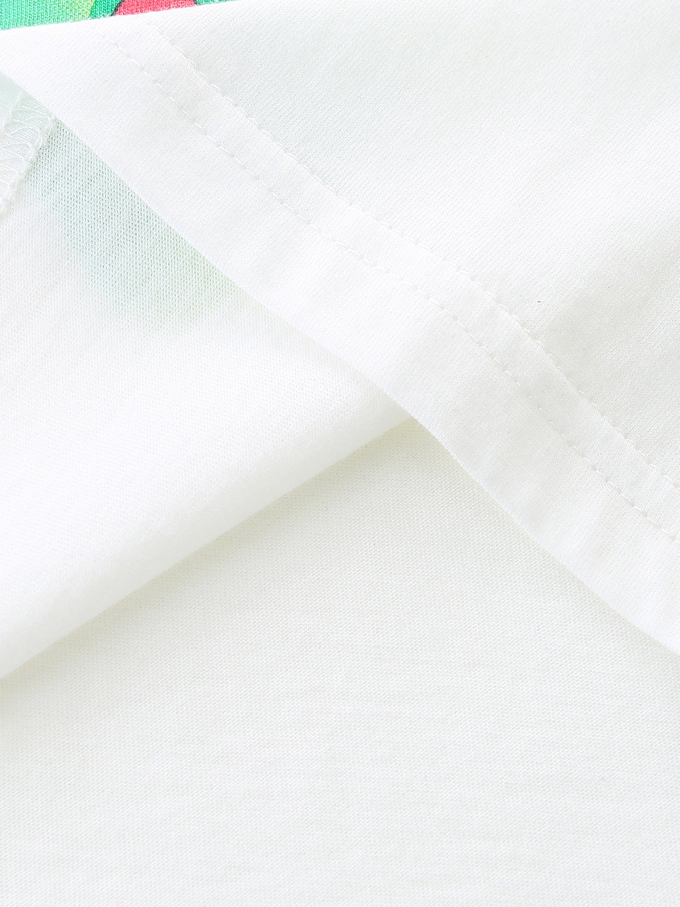 White cotton t-shirt detail showing seam and subtle butterfly print fabric.
