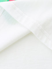 White cotton t-shirt detail showing seam and subtle butterfly print fabric.