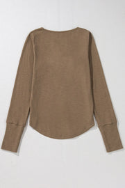 Coffee brown ribbed long sleeve Henley blouse with curved hem and cuffed sleeves.
