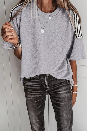 Grey relaxed t-shirt with black and white shoulder stripes, crew neck, short sleeves.