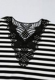 Black and white striped blouse with ornate black lace neckline detail.