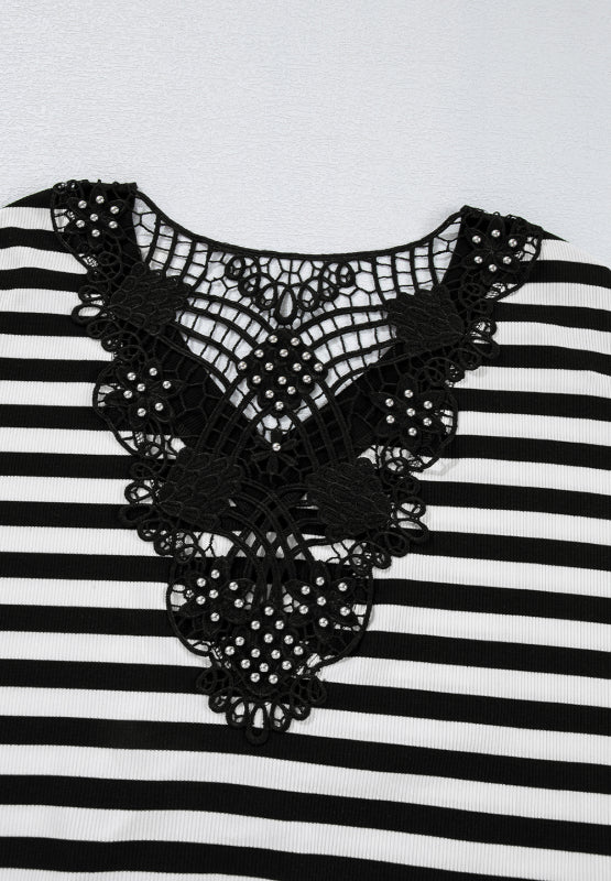 Black and white striped blouse with ornate black lace neckline detail.