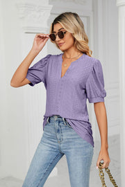 Purple perforated puff sleeve blouse with V-neck and keyhole detail.