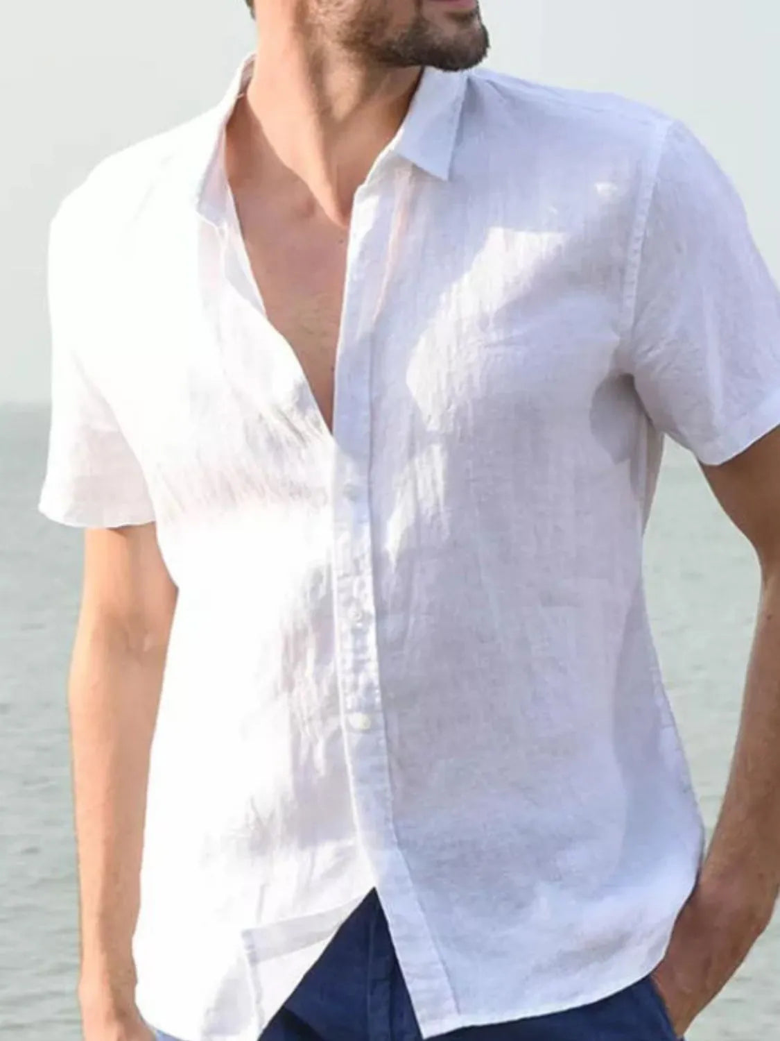 White linen resort shirt, short sleeve, buttoned, relaxed fit, worn open collar