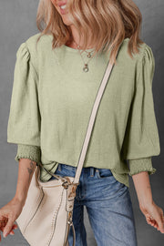 Sage textured puff sleeve blouse with elastic cuffs and crew neck.