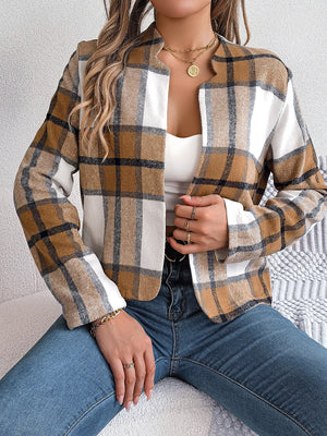 Collarless plaid cropped jacket in camel and white with black accents, open front.