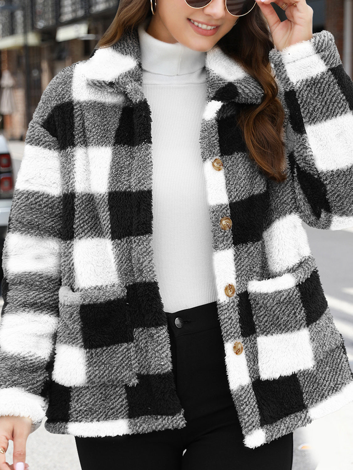 Plaid sherpa overshirt jacket in black and white buffalo check with button front and pockets.