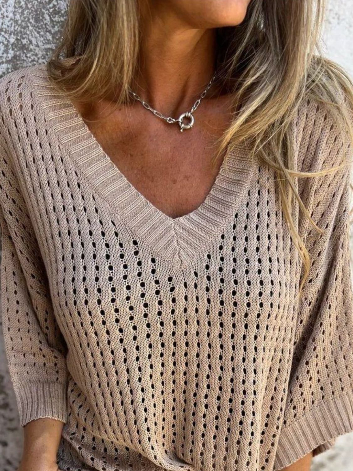 Open-knit tan V-neck sweater with a slouchy fit and ribbed cuffs.