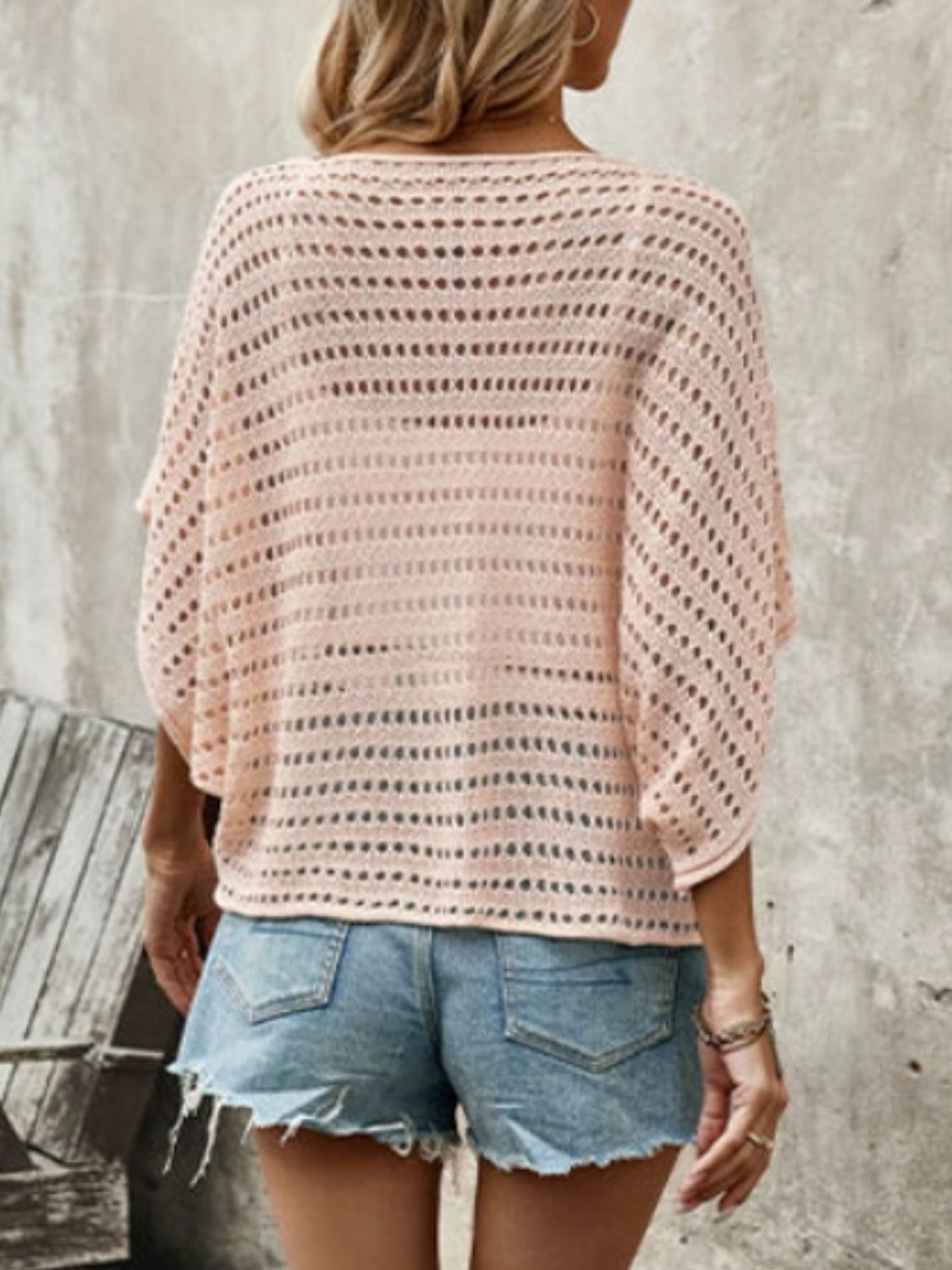 Blush pink open-knit batwing sleeve sweater with a relaxed fit.