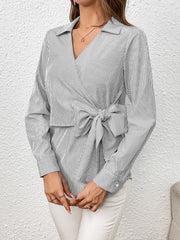 Gray striped wrap blouse with a large bow detail and V-neck.