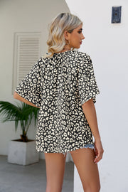 Black leopard print v-neck blouse with short sleeves and a flowy fit.