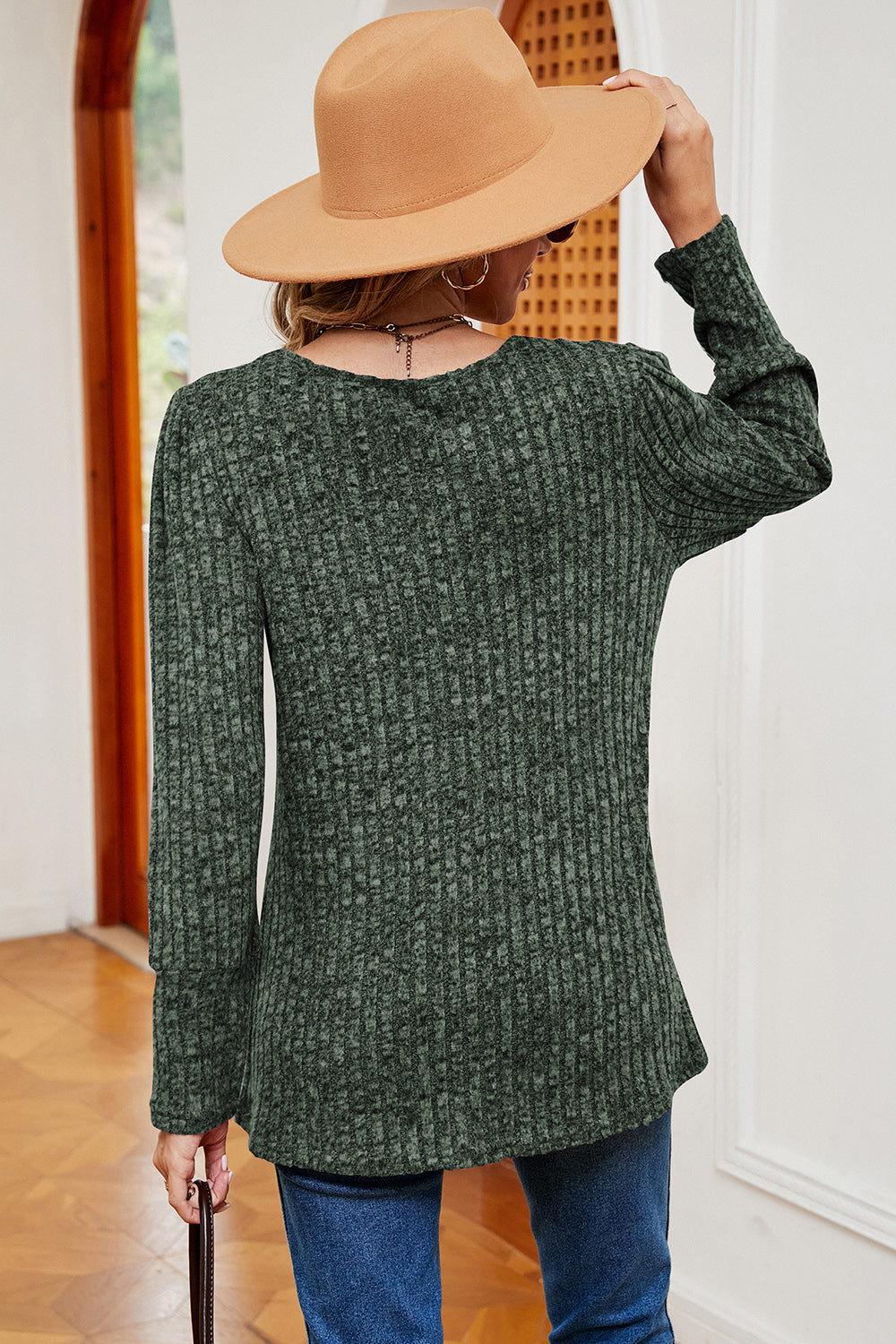 Dark green ribbed button-down top with asymmetric hem and long sleeves.