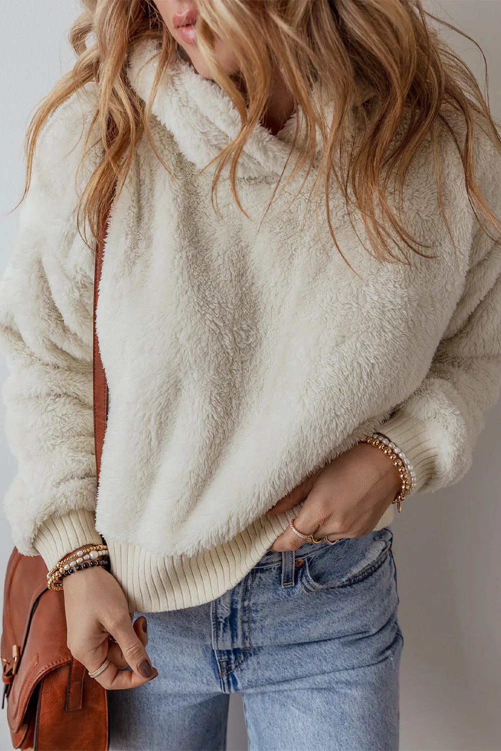 Beige plush fleece cropped hoodie with ribbed cuffs and hem.