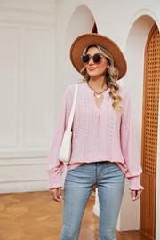 Blush pink eyelet detail poet sleeve blouse with V-neck and ruffled cuffs.