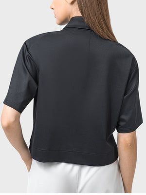 Black cropped polo sportif top with short sleeves and a collar.