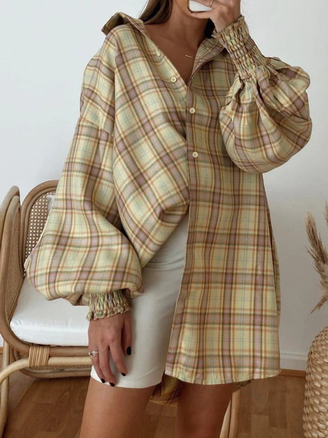 Plaid oversized shirt with balloon sleeves and smocked cuffs in a brown, yellow, and purple plaid pattern.