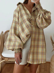 Plaid oversized shirt with balloon sleeves and smocked cuffs in a brown, yellow, and purple plaid pattern.