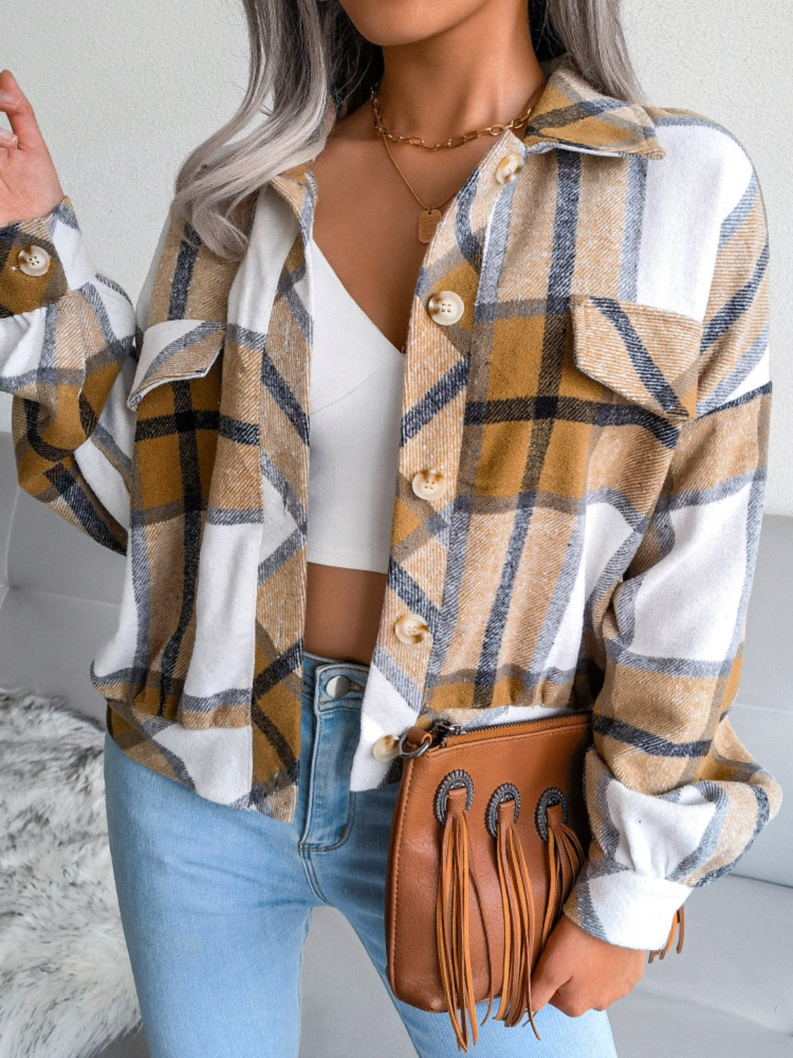 Oversized plaid shacket in camel with patch pockets and button front, worn open over a white crop top.
