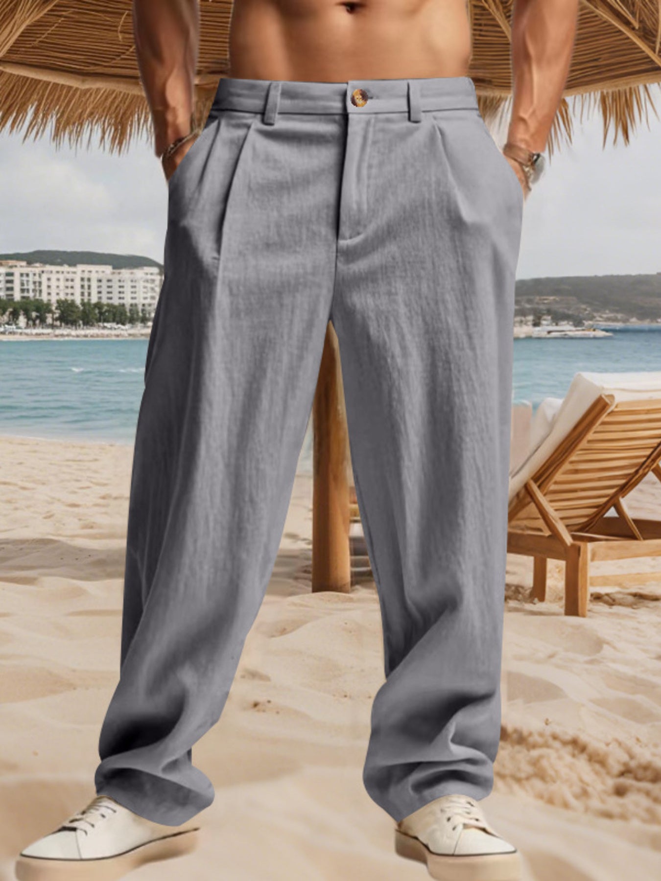 Men's grey relaxed fit sweatpants with pleats and a button closure.