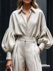 Khaki lantern sleeve shirt and wide-leg pants set with button-up detail and belted waist.