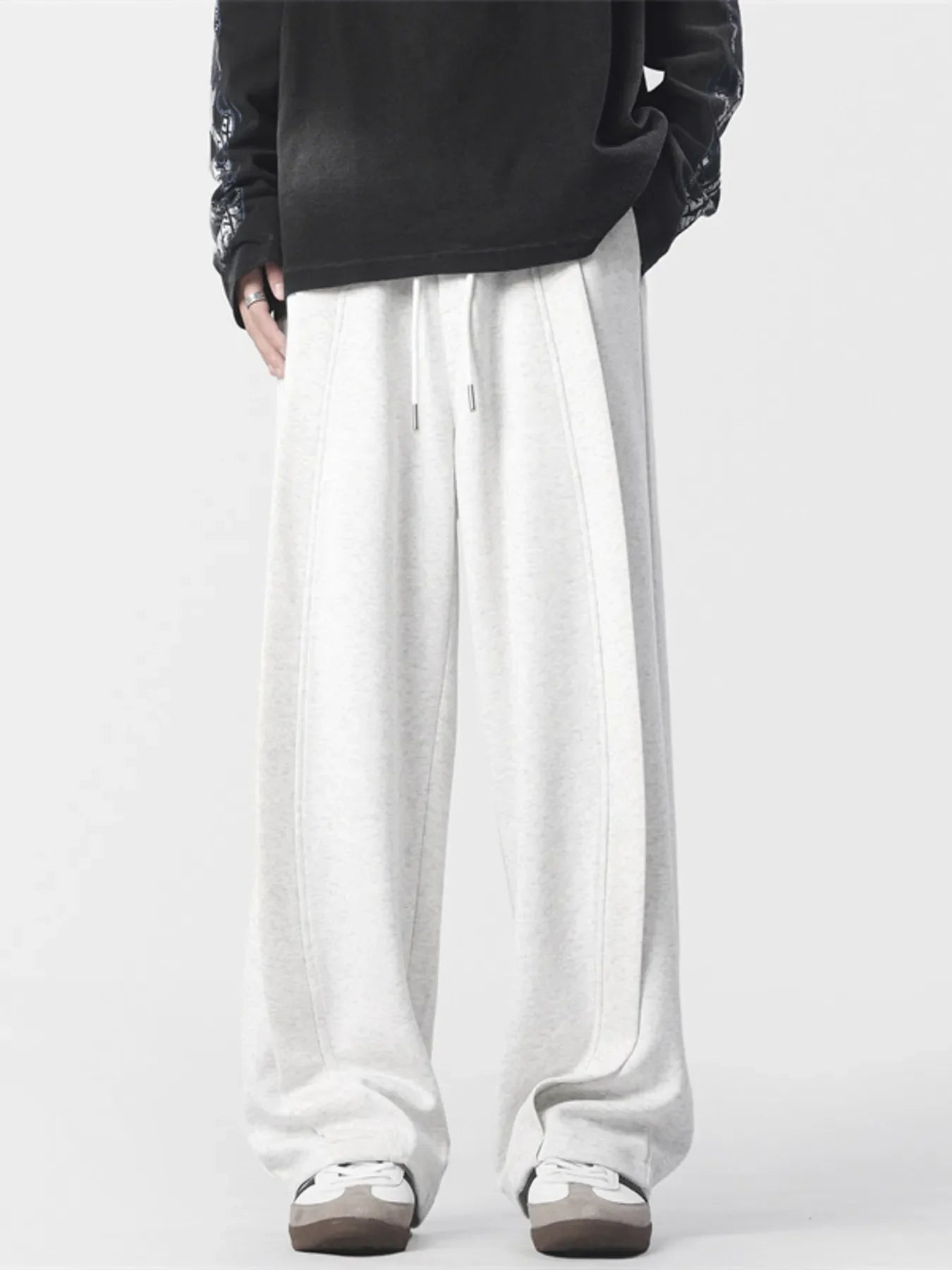 Men's light grey loose fit drawstring joggers with stitched seams
