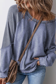 Waffle knit raglan sweatshirt in Dusty Blue with contrast sleeves and raw hem details.