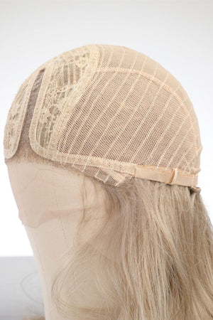 Blonde lace front wig cap detail with adjustable strap and lace trim.