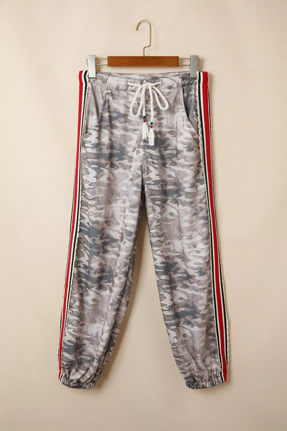 Maternity pants with camo print, drawstring waist, and striped side detail.