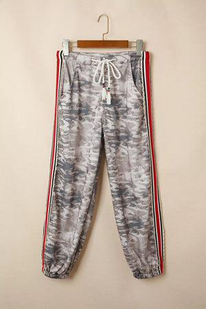 Maternity pants with camo print, drawstring waist, and striped side detail.
