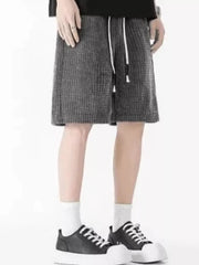 Men's dark gray waffle-knit casual shorts with drawstring waist.