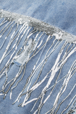 Denim trucker jacket with sequin fringe detail and distressed accents.