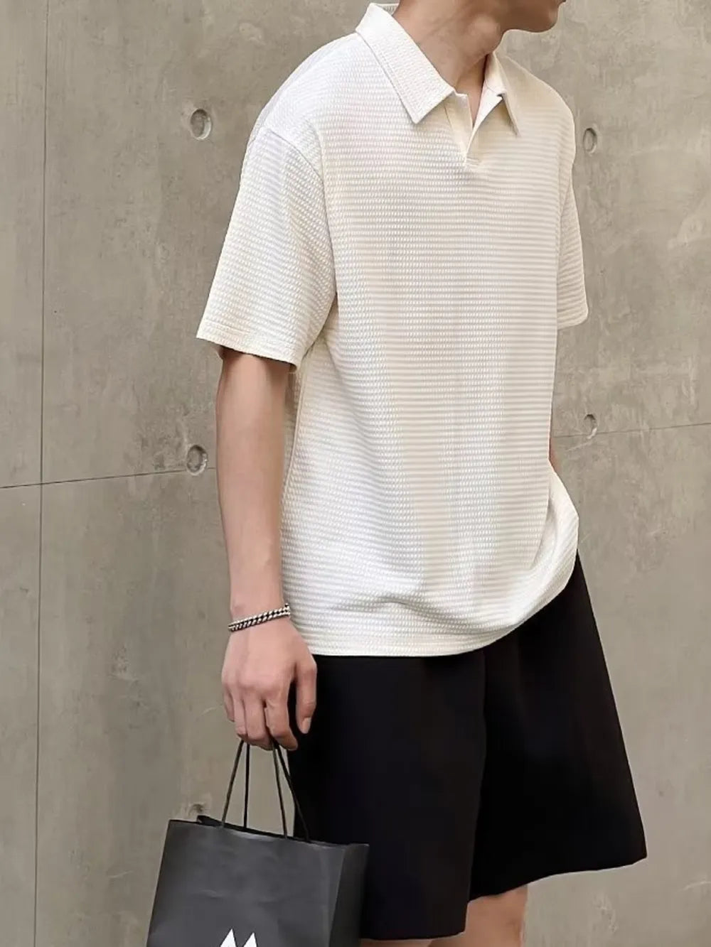 Men's eggshell textured waffle knit polo shirt with short sleeves and button collar.
