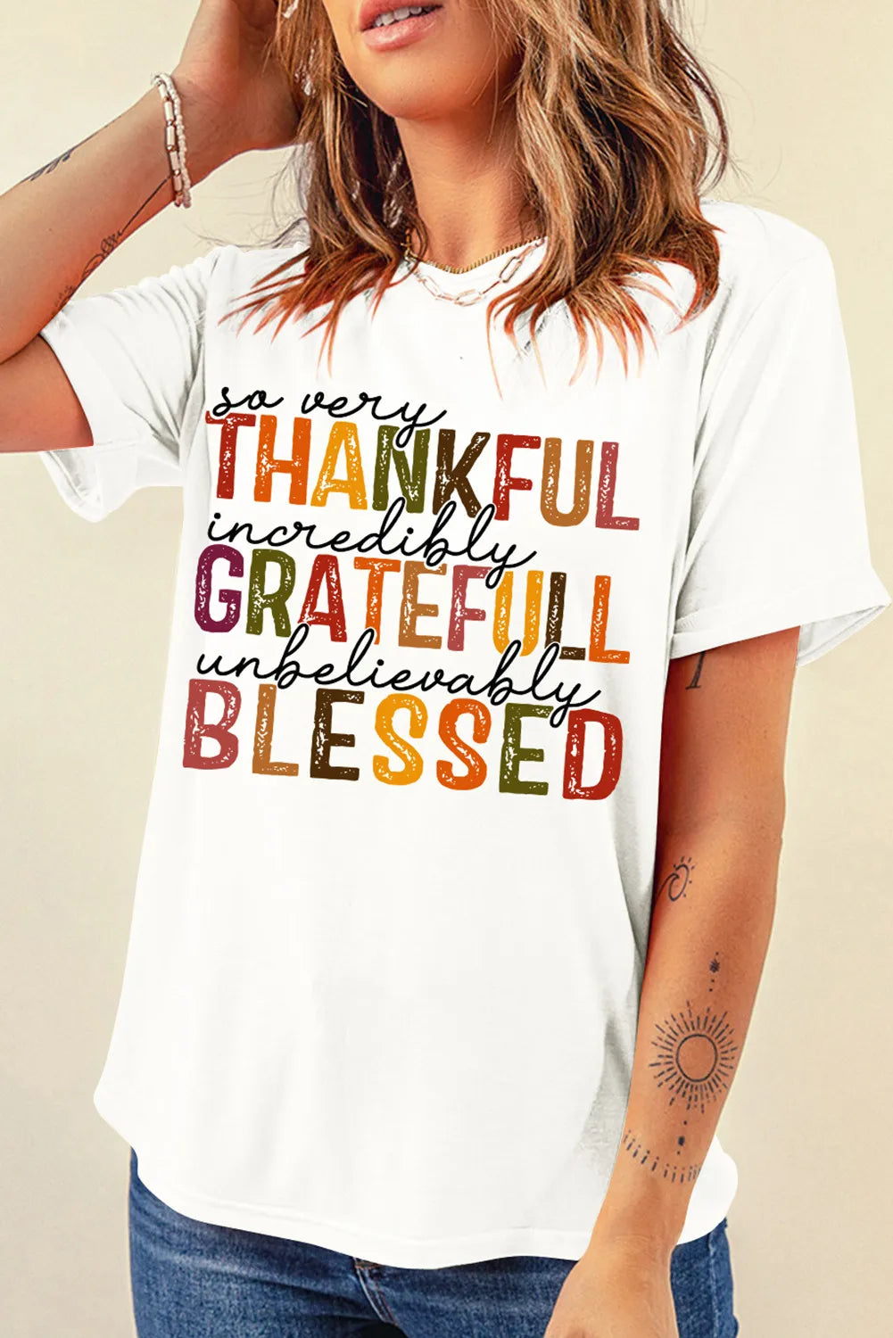 White cotton crewneck tee with colorful "Thankful, Grateful, Blessed" typography graphic.