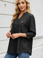 Black denim henley blouse with V-neck, button placket, and chest pockets.