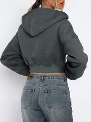 Dark gray cropped zip-up hoodie with ribbed hem and a raw edge detail.