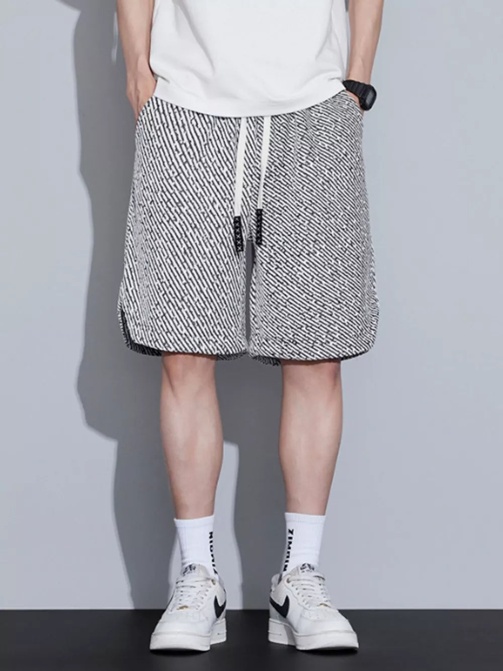 Men's boxer shorts with a black and white abstract pattern and adjustable drawstring.