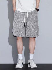 Men's boxer shorts with a black and white abstract pattern and adjustable drawstring.