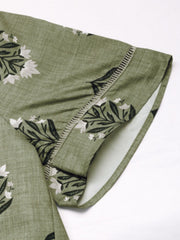 Botanical print blouse in matcha green with short sleeves and decorative stitching detail.