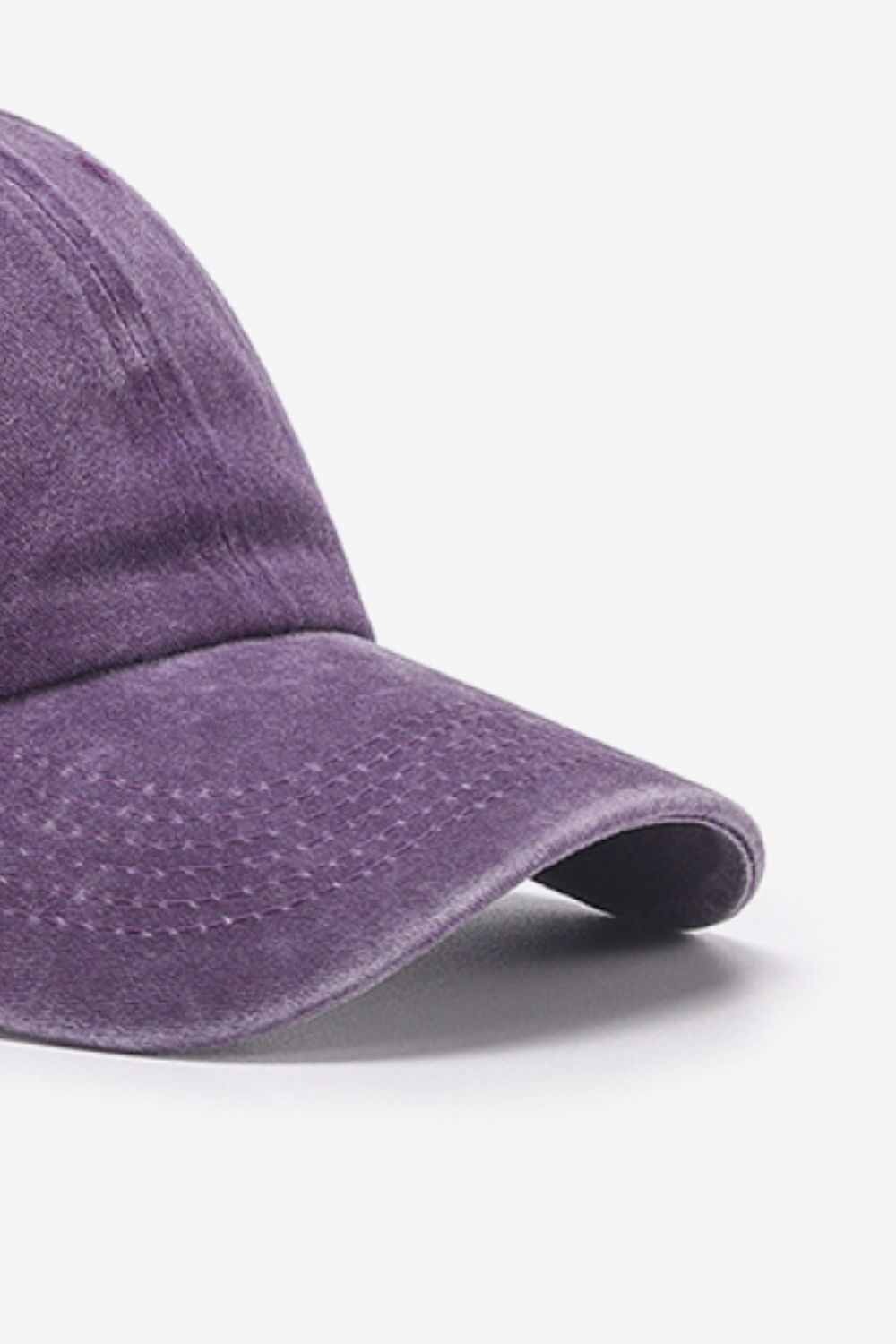 Washed cotton baseball cap in purple with stitched detail on the brim.