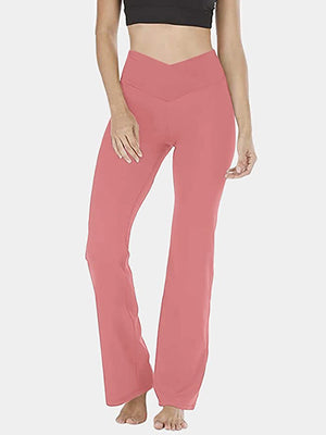 Burnt Coral V-waist flare leg activewear pants with a high rise and bootcut hem.