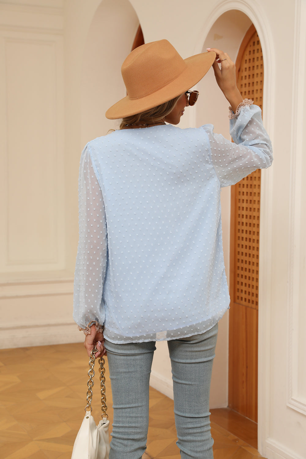 Misty Blue embroidered Swiss dot blouse with poet sleeves and ruffled cuffs.