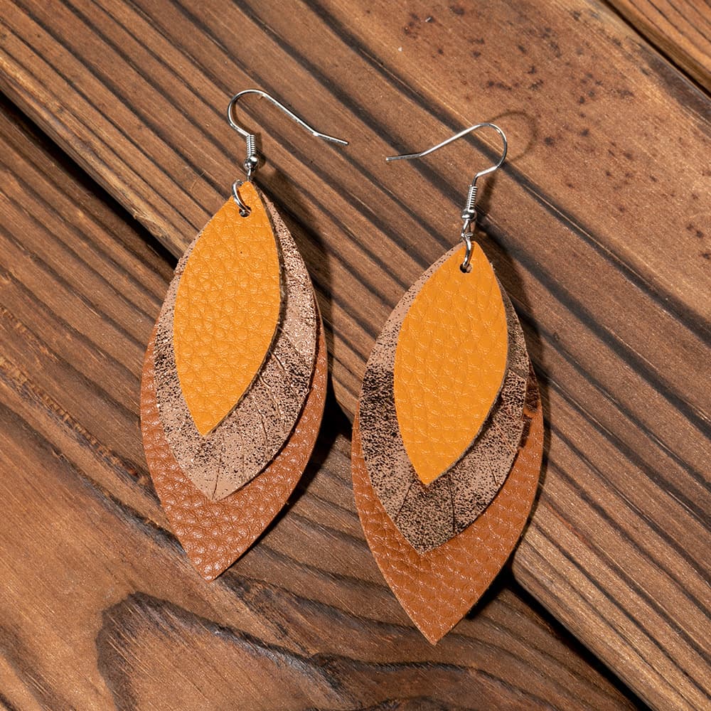Layered faux leather teardrop earrings in brown and orange with metallic accents.