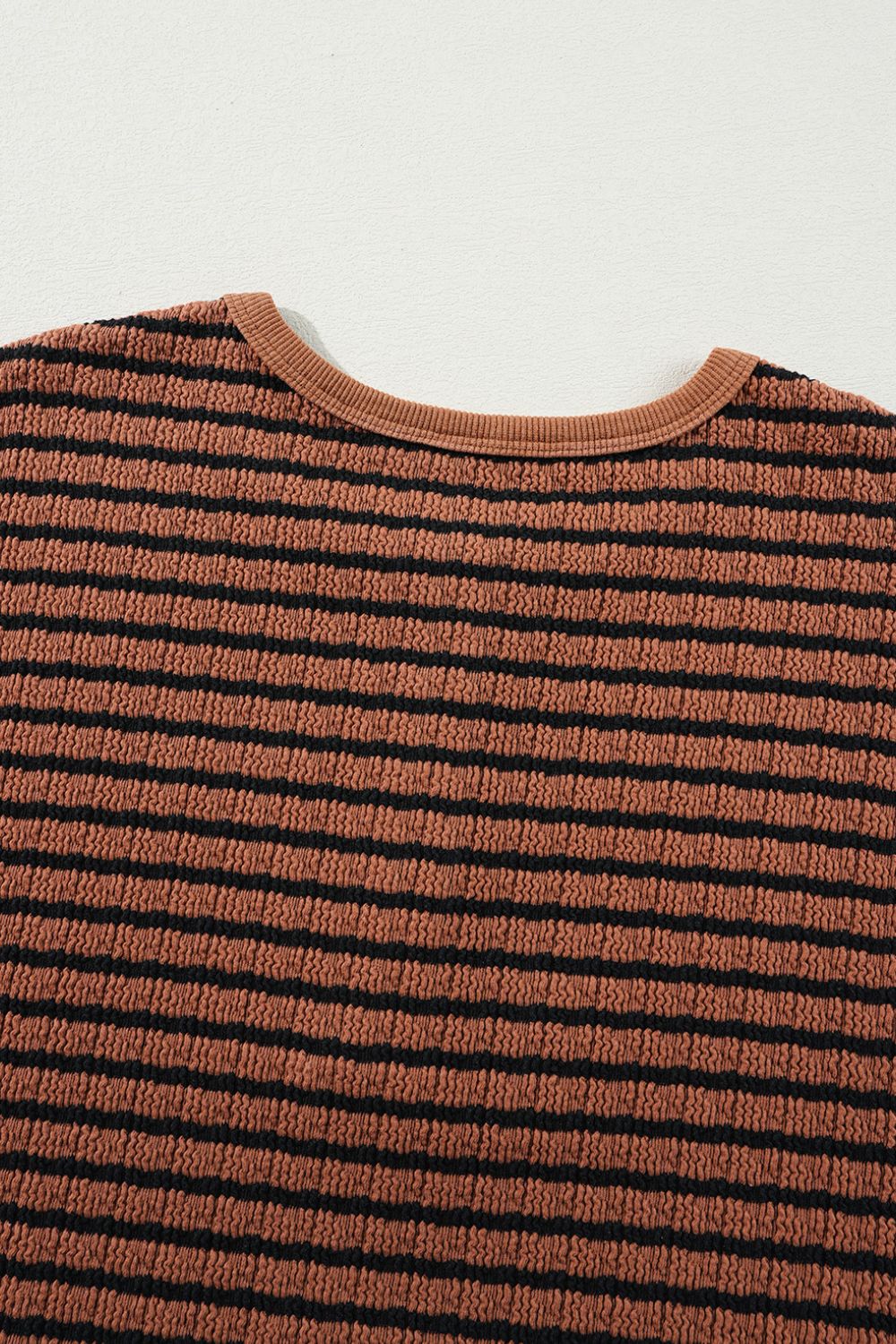 Textured henley stripe knit top in caramel with black stripes and crew neck.