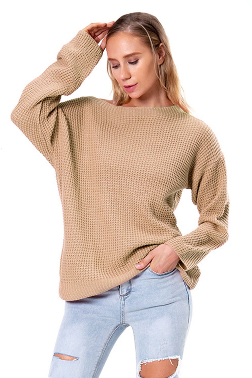 Tan waffle knit off-shoulder sweater with long sleeves and a relaxed fit.