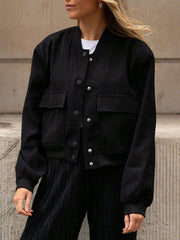 Black bomber jacket with button closure, two chest pockets, and ribbed cuffs and hem.