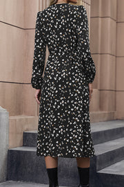 Black floral midi wrap dress with button front and long sleeves.